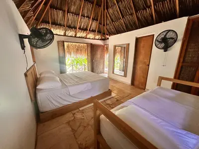 a bedroom with two beds and a window at Orika del Mar Hotel in Isla Grande