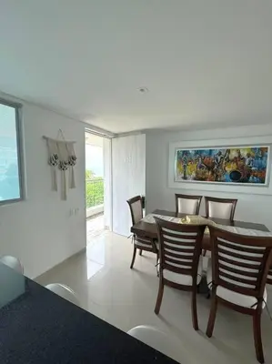 a dining room with a table and chairs at Amazing Beachfront Apartment in Cartagena de Indias