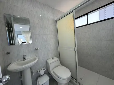 a bathroom with a toilet and a sink and a shower at Portofino Bocagrande 2 habitaciones in Cartagena de Indias