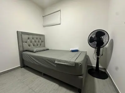a bedroom with a bed with a fan on it at 3BR AC LUXURY APARTMENT CLOSE TO THE AIRPORT Beach & THE HISTORIC CENTER in Cartagena de Indias