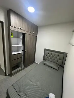 a small room with a bed and a closet at 3BR AC LUXURY APARTMENT CLOSE TO THE AIRPORT Beach & THE HISTORIC CENTER in Cartagena de Indias