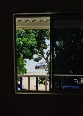 a window with a view of a beach from a house at Casa Victoria in San Onofre
