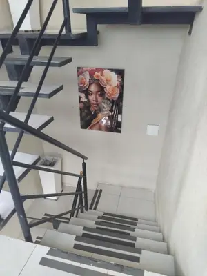 a staircase with two pictures on the wall and a stair case at Hostel HA1 in Cartagena de Indias