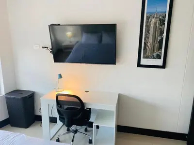 a bedroom with a desk with a bed and a tv on the wall at Apto 2301 vista al mar Palmetto elíptic in Cartagena de Indias