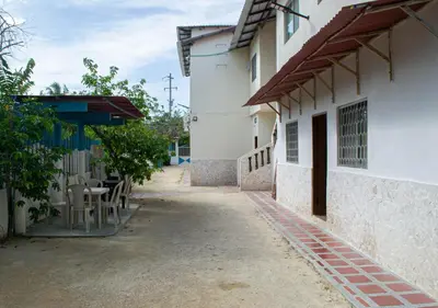 an alley with tables and chairs in a building at Alojamiento Familiar #3 - Un terruño en la costa in Puerto Viejo