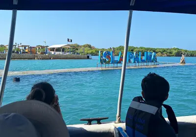 two people sitting on a boat looking at the water at Alojamiento Familiar #4 - El mejor mar y playas in Puerto Viejo