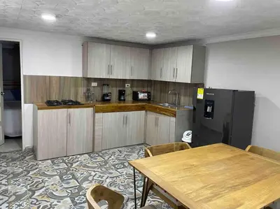 a kitchen with a wooden table and a refrigerator at Beautiful house en el centro in Cartagena de Indias