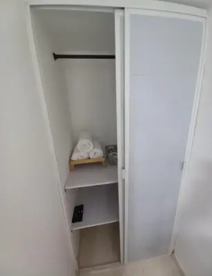 a walk in closet with white walls and white shelves at Hostal Doña Betty 2 in Cartagena de Indias