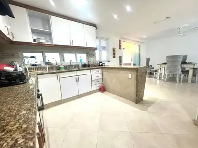 a large kitchen with white cabinets and a tile floor at Private House - 4 Pisos - 100 Mts de la playa in Cartagena de Indias