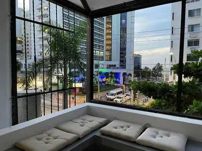 a room with a couch in front of a large window at Apartamento Loft in Cartagena de Indias
