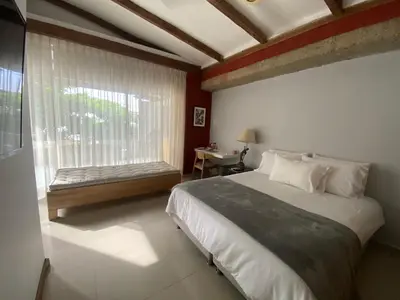 a bedroom with a bed and a window with a bench at Apartamento Loft in Cartagena de Indias