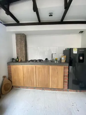 a kitchen with a sink and a black refrigerator at Apartamento Loft in Cartagena de Indias