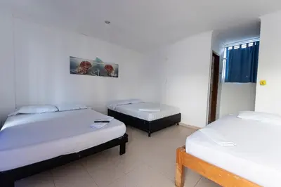a room with two beds in a room at Hotel Be Real in Coveñitas
