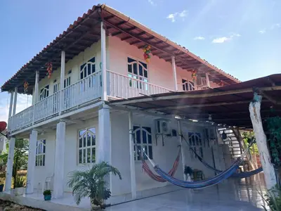 a house with hammocks in front of it at Caribean campestre in Calao