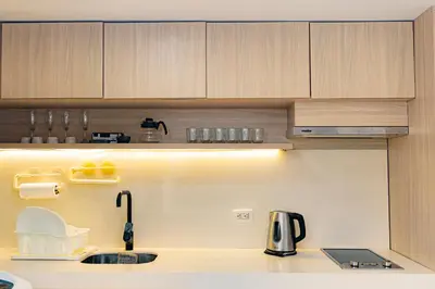 a kitchen with wooden cabinets and a sink at Apartamento frente al mar, vista al centro de Cartagena in Cartagena de Indias