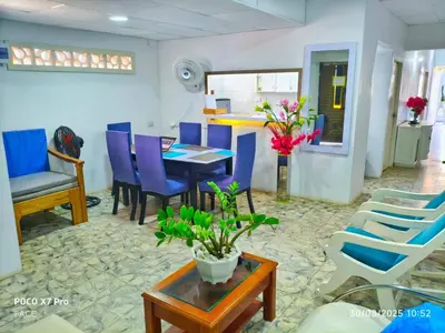 a dining room with blue chairs and a table at Casa Esmeralda in Cartagena de Indias