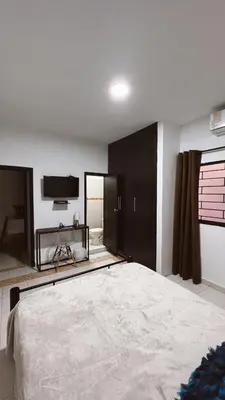 a bedroom with a large bed and a flat screen tv at Casa de Huesped Sky Blue Barranquilla Colombia in Ciudad Jardín