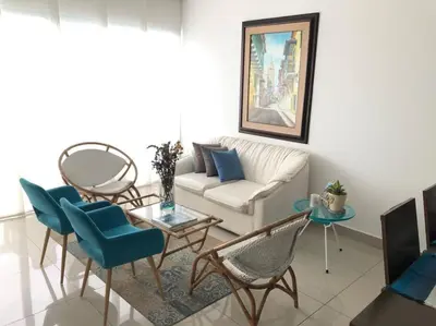 a living room with a couch and a table and chairs at Cartagena Espectacular apartamento en bocagrande in Cartagena de Indias
