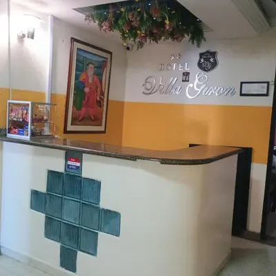 a counter in a restaurant with a painting on the wall at Hotel Villa Giron inn in Barranquilla