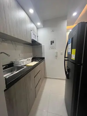 a small kitchen with a refrigerator and a sink at Bello apartamento con visita al mar in Cartagena de Indias