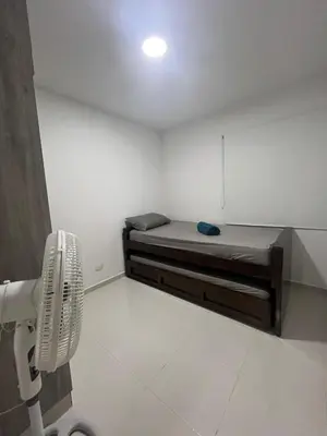 a small room with a bed and a fan at Bello apartamento con visita al mar in Cartagena de Indias