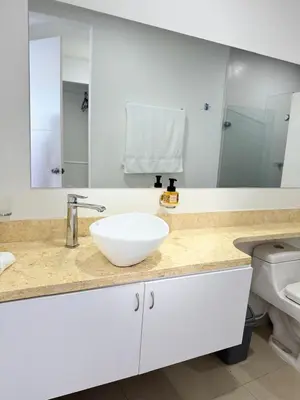 a bathroom with a white sink and a toilet at Alojamiento Cartagena frente Al Mar in Cartagena de Indias