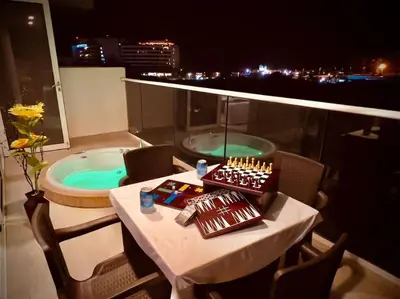 a bathroom with a table and a tub on a balcony at Martinique Apto Private Jacuzzi - Netflix-Disney-Prime in Cartagena de Indias