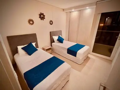 a hotel room with two beds and a window at Martinique Apto Private Jacuzzi - Netflix-Disney-Prime in Cartagena de Indias