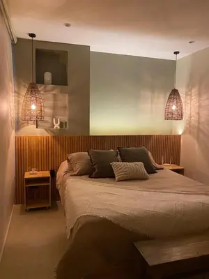 a bedroom with a large bed with two lamps at Casa frente a la playa in Salina de Rey
