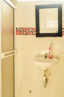 a bathroom with a sink and a mirror at MANGO BiCHE - HOUSE in Cartagena de Indias