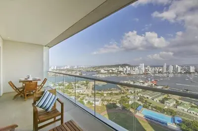 a balcony with a view of the water and a city at New Apartment With 1 Bedroom In H2 in Cartagena de Indias