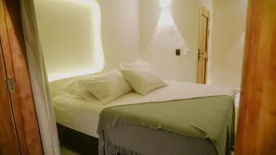 a small bed with two pillows on top of it at Talam House Coveñas by Bernalo Hotels in Coveñas