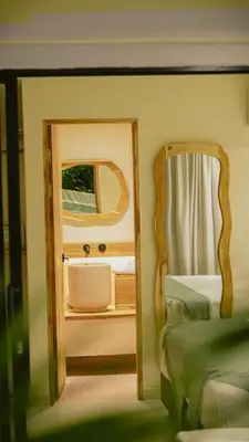 a bedroom with a mirror next to a bed at Talam House Coveñas by Bernalo Hotels in Coveñas