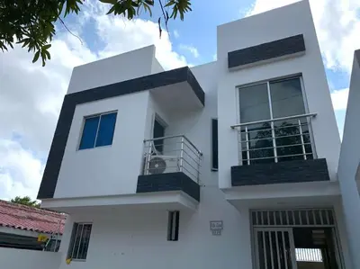 a white house with a balcony on the side of it at Hermosa casa con parqueadero en excelente ubicación in Barranquilla