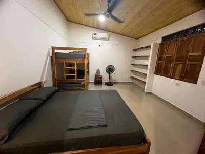 a bedroom with a bed and a ceiling fan at Cabaña OtraParte in Rincón