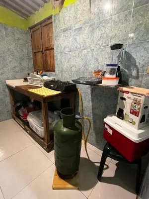 a kitchen with a stove and a counter in a room at Cabaña OtraParte in Rincón