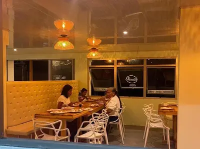 two women sitting at a table in a restaurant at Hotel Miramar Baru in Playa Blanca