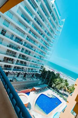 a large building on the beach with a swimming pool at Caribbean Beachfront Getaway in Cartagena de Indias