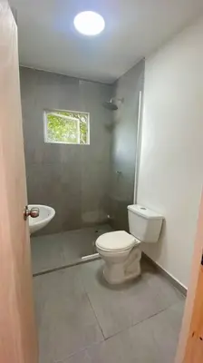 a bathroom with a toilet and a sink at Casa Mar in Puerto Colombia