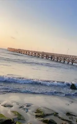 a long pier in the ocean with waves at Casa Mar in Puerto Colombia