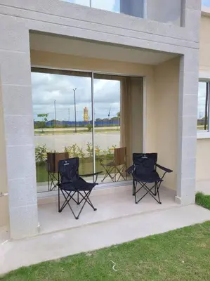 a group of chairs sitting on a porch with a window at Refugio de ensueño in Manzanillo del Mar