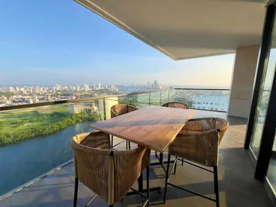 a table and chairs on a balcony with a view at Luxury Murano Cartagena Condo in Cartagena de Indias