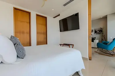a bedroom with a white bed and a tv at Luxury H2 piso 19 / Sea Bay View & Historic Center in Cartagena de Indias