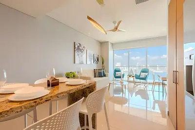a kitchen and dining room with a view of the ocean at Luxury H2 piso 19 / Sea Bay View & Historic Center in Cartagena de Indias