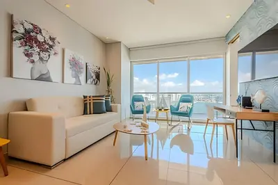 a living room with a white couch and a table at Luxury H2 piso 19 / Sea Bay View & Historic Center in Cartagena de Indias