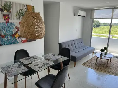 a living room with a table and chairs and a couch at Apartamento Económico En Coveñas in Coveñas