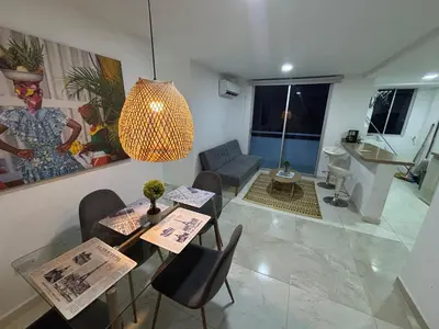 a living room with a table and chairs and a living room at Apartamento Económico En Coveñas in Coveñas