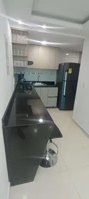 a kitchen with a black counter top in a room at CARTAGENA CONFORT APARTAMENTO NUEVO y COMPLETO in Cartagena de Indias