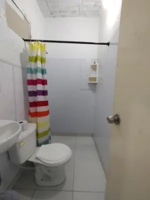a bathroom with a toilet and a shower curtain at casa Marez in Cartagena de Indias