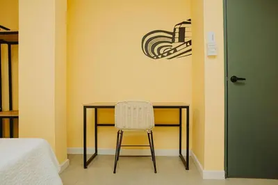 a desk with a chair next to a door at Laguito Houstel Large in Cartagena de Indias